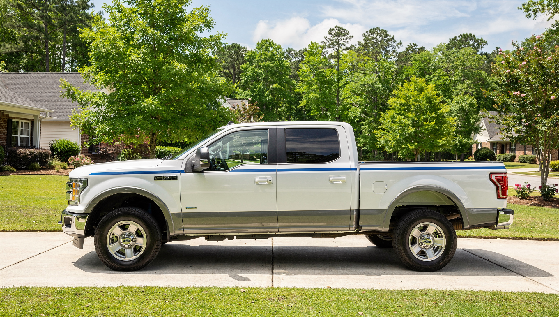 A clean Septic Blue service truck with a blue accent stripe parked on a Charlotte residential driveway